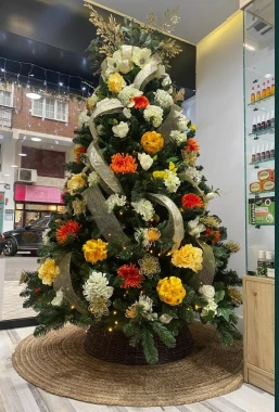 Árbol de Navidad con flores en naranja, amarillo y blanco, ejemplo de estilo a elegir