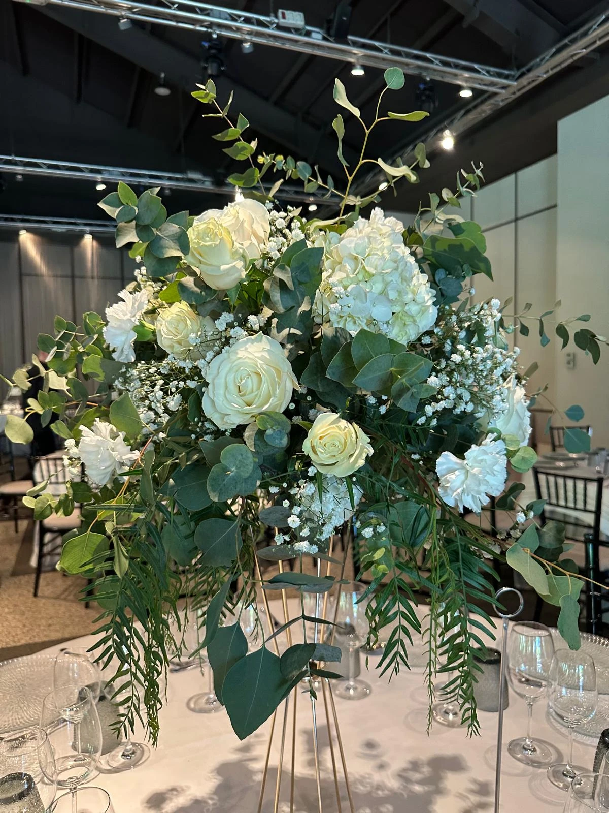 Centro de mesa de boda con rosas blancas, hortensias y eucalipto